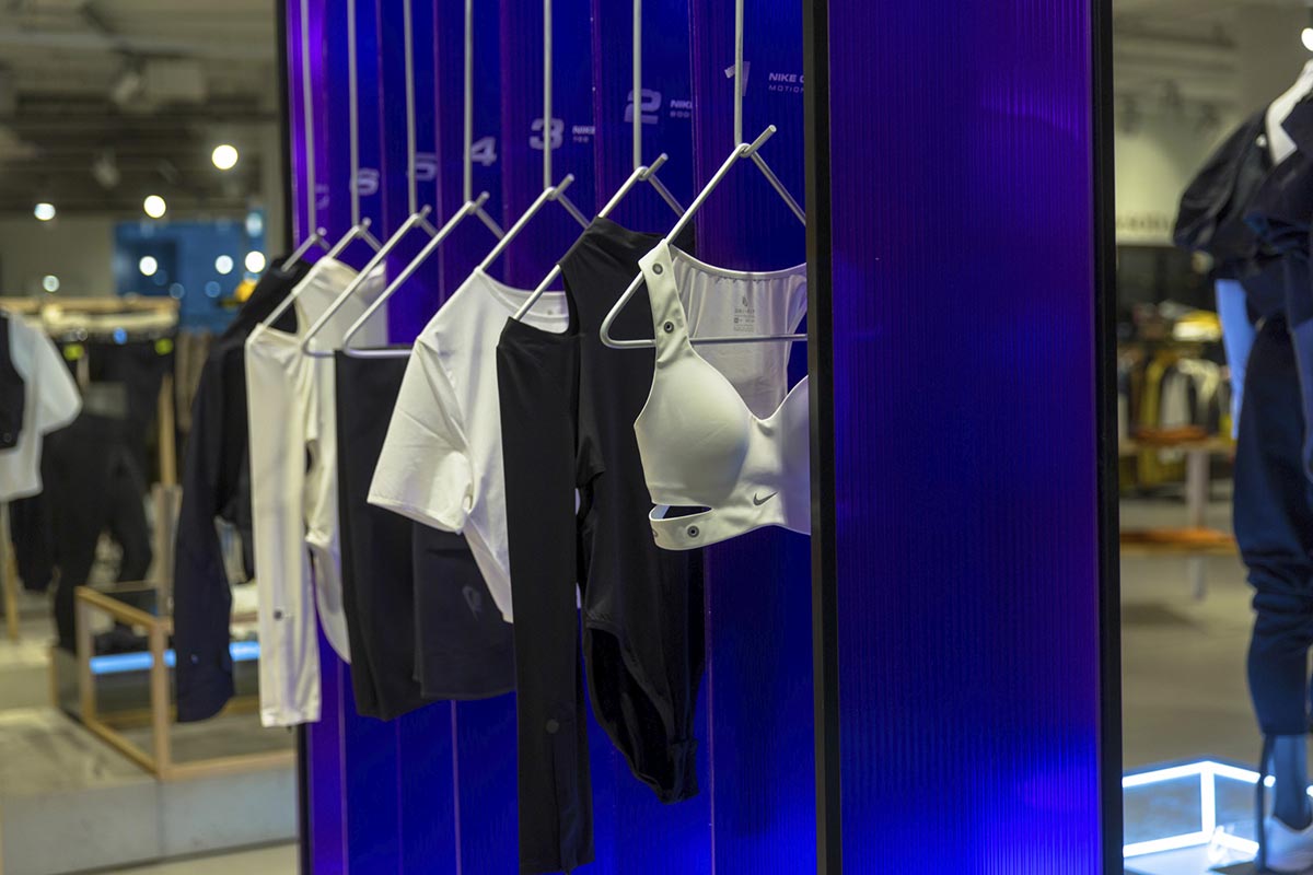 Nike City Ready campaign design - custom hanging rails with purple polycarbonate backdrop
