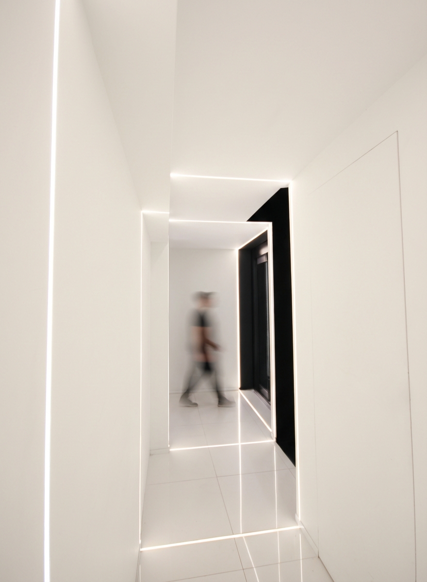 White corridor with light profiles GameStop Milan