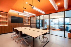 LivinUp SeiMilano coworking, meeting room with glass wall and screen, interior design amenities Milan