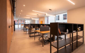 LivinUp SeiMilano coworking, operational desks in wood with dividers, interior design amenities Milan