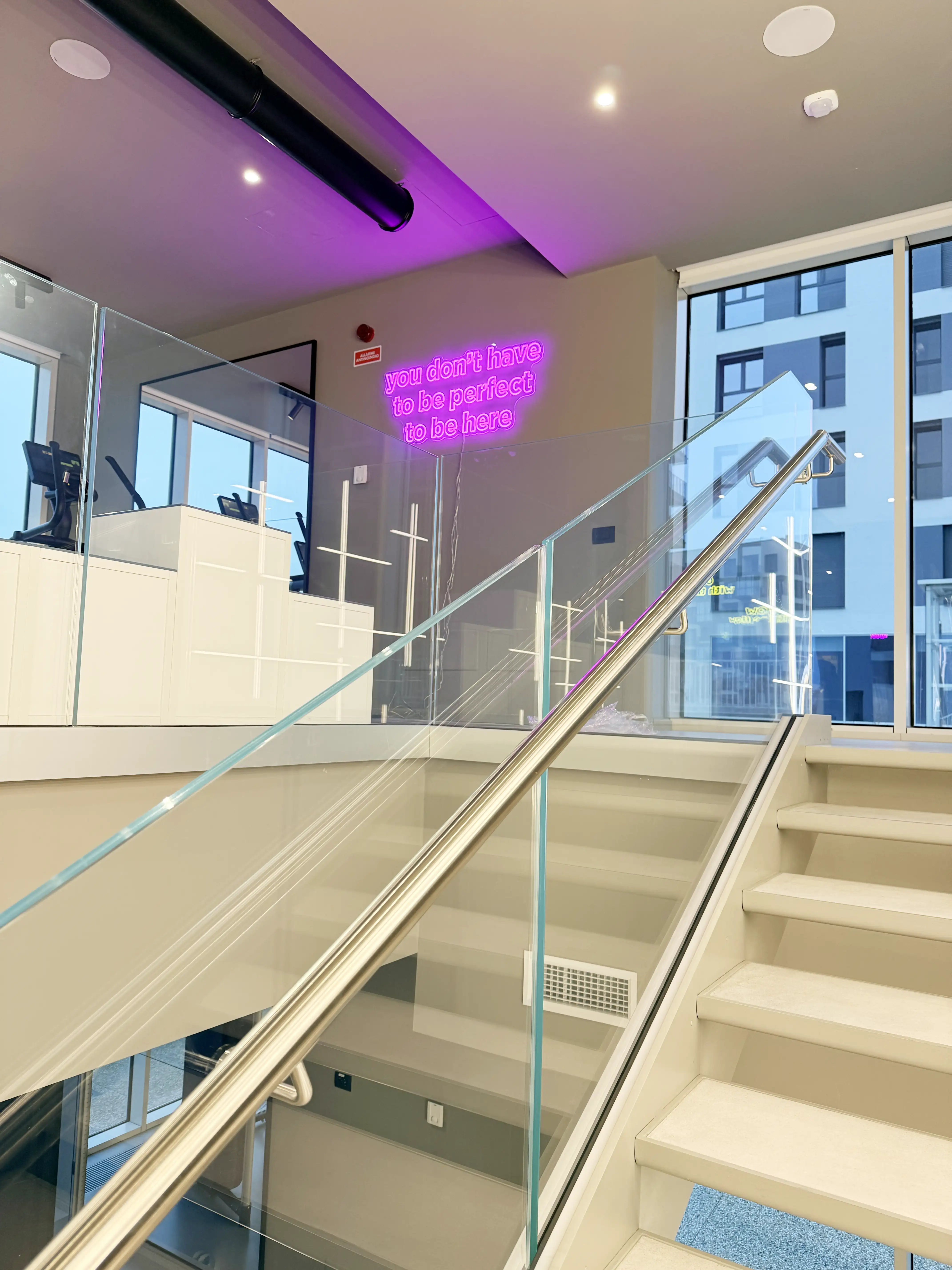 AMenities Livinup milano gym neon quote and white staircase