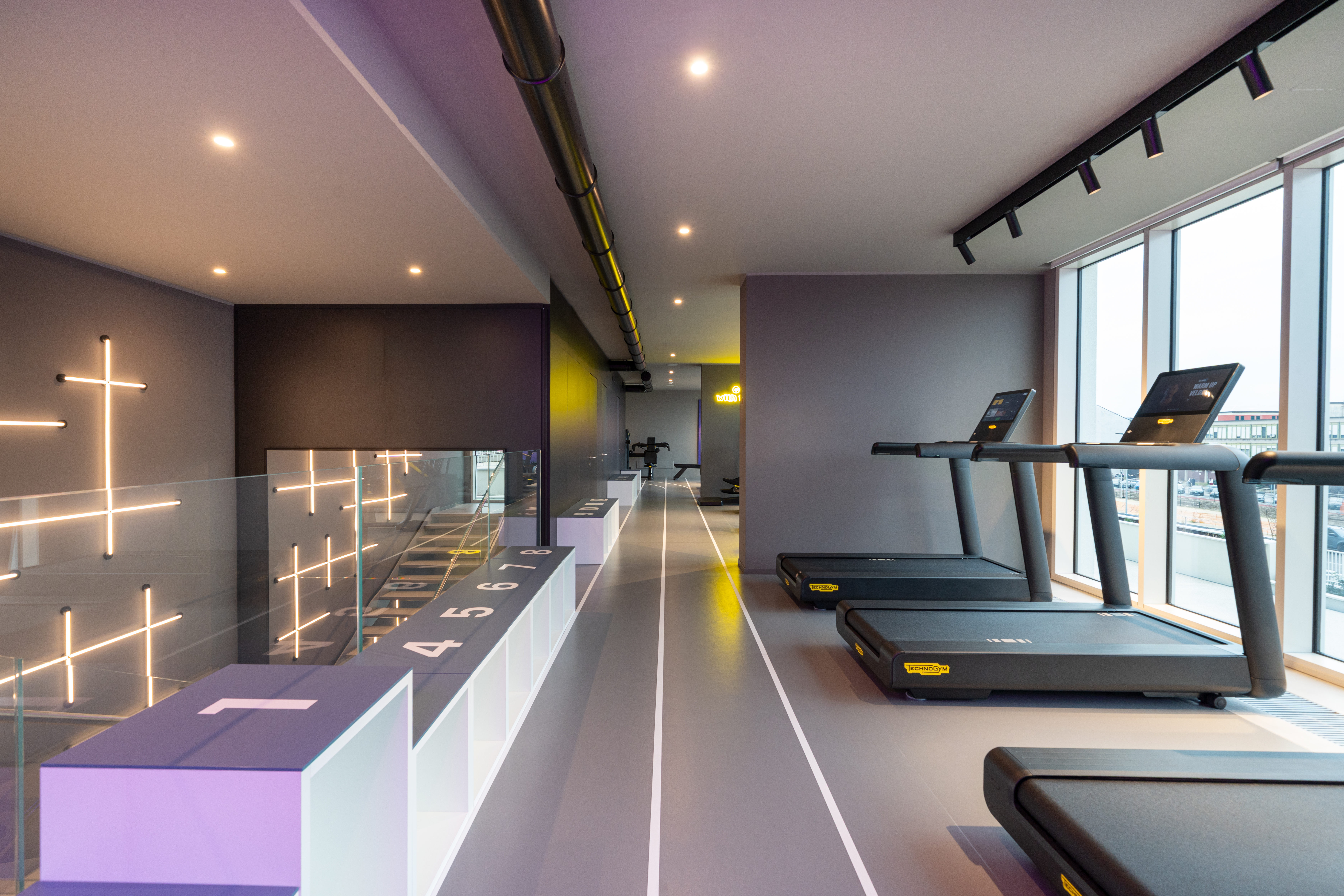 LivinUp SeiMilano gym across two levels, view over the city, interior design amenities Milan